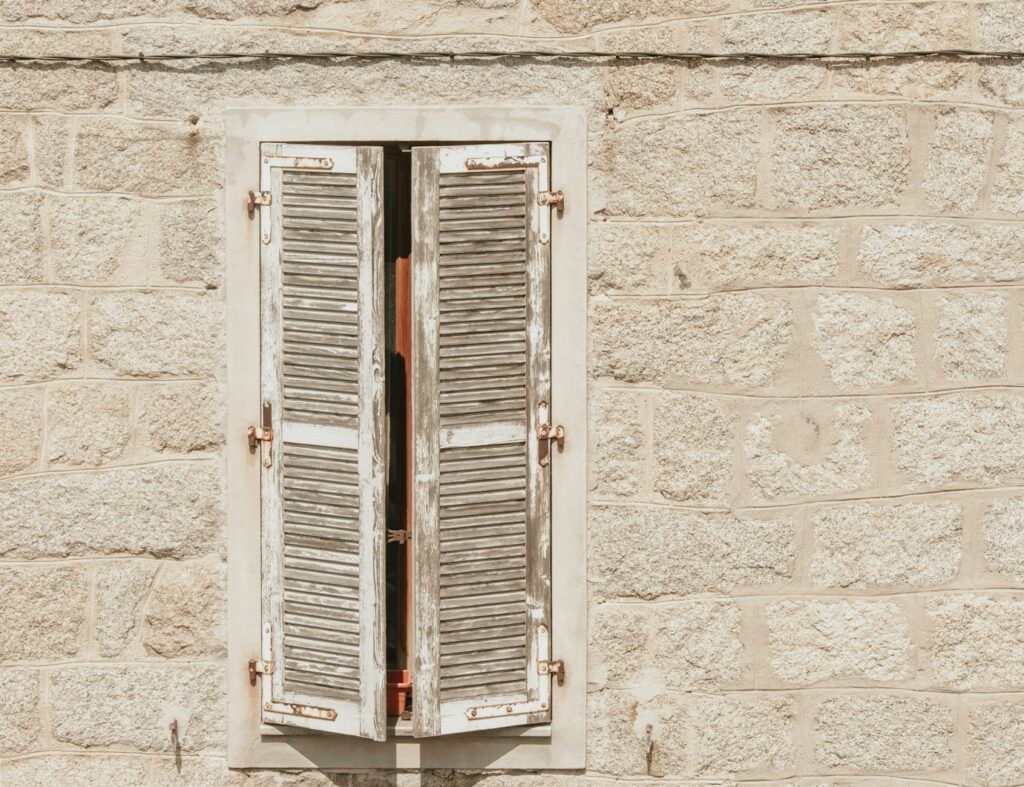 white wooden window on white concrete wall